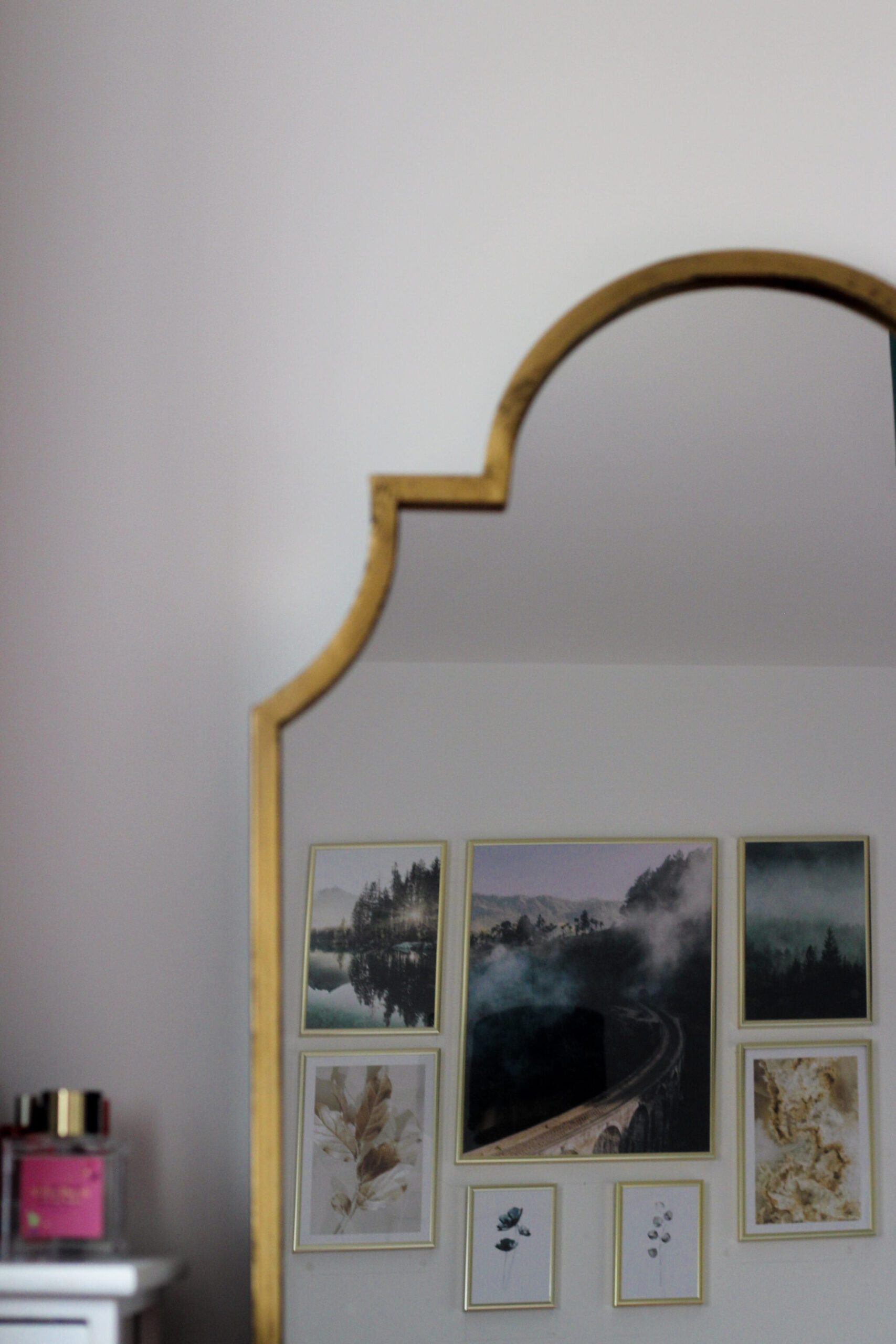 Posters reflected in large golden mirror