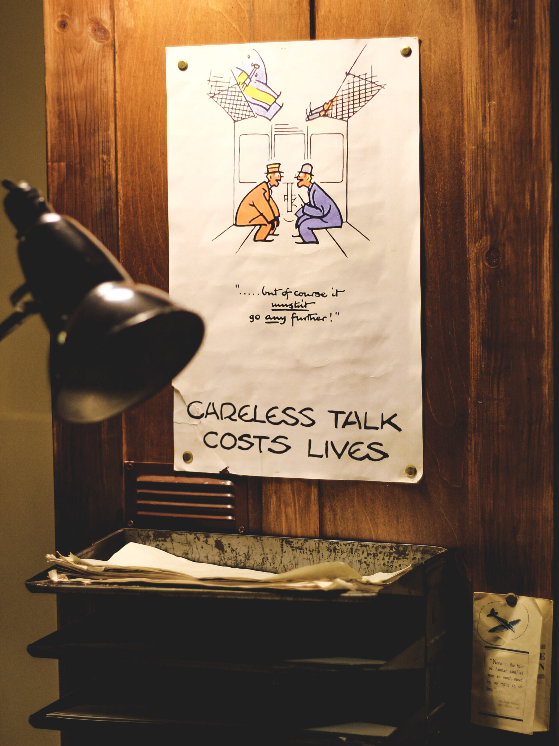 A mock sign at Bletchley Park reads "careless talk costs lives"